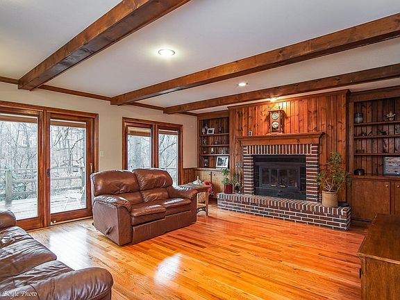 First Floor Recreation Room with fireplace, hardwood floors and access to deck.