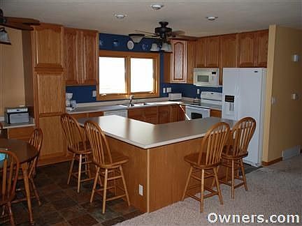Kitchen with oak cabinets and breakfast bar.
