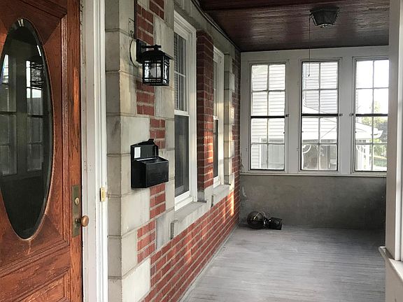 View of closed front porch and front door of the 1st floor apartment.