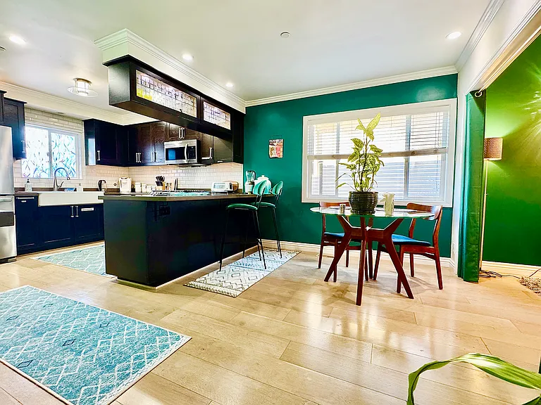 Open concept kitchen equipped with all new stainless steel appliances, breakfast nook, Living room