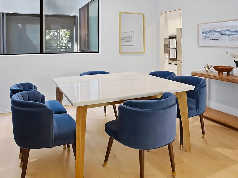 Dining room with view into kitchen.