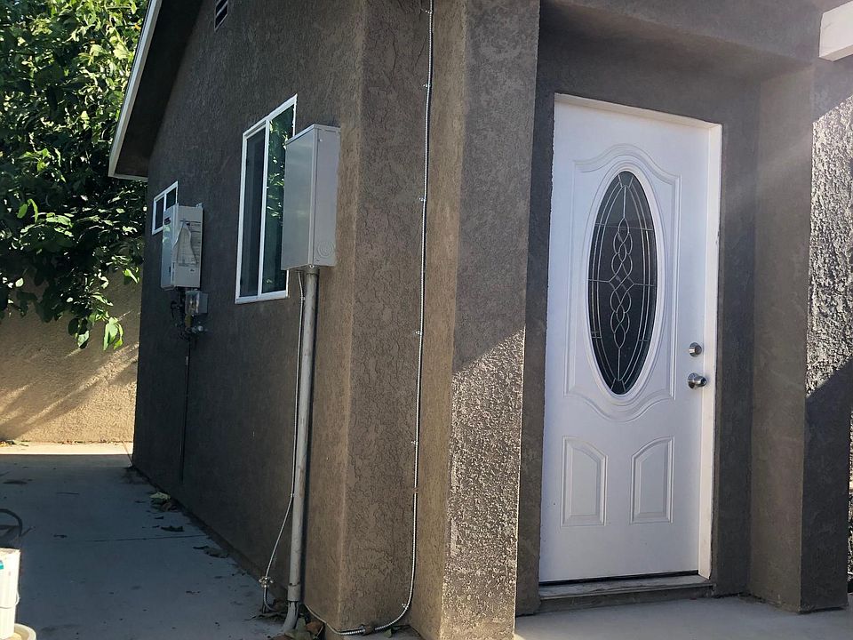 Front with side area. There is room for a small table and chairs in the back under the avocado tree, and room for a small grill in the back.
