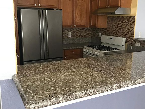 cute kitchen with granite countertops and glass tile back sp