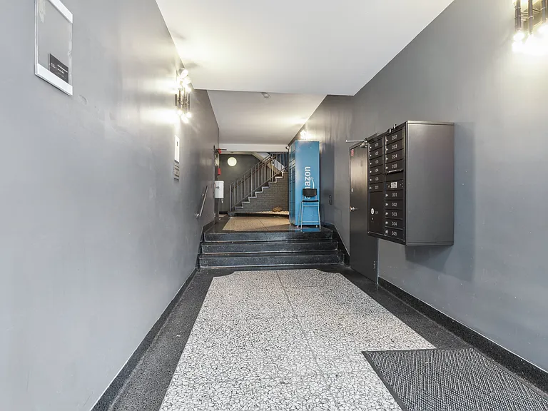 Hallway with staircase and mailboxes