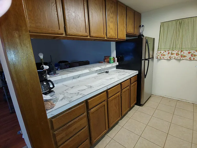 Galley Kitchen with bar to living room.