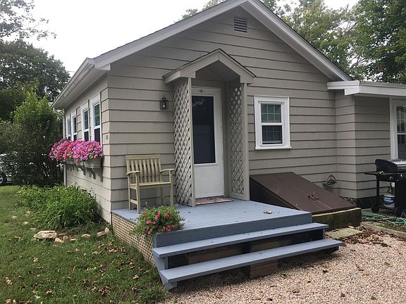 Small deck with views of river. stone driveway for off stree