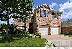 Beautiful front of this home with gorgeous landscaping!