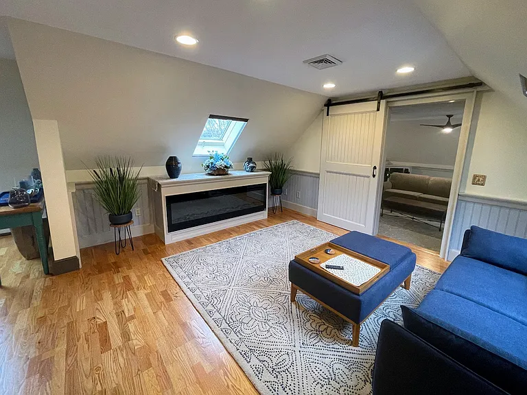 Seating area w/electric fireplace view into living room from the kitchen bar