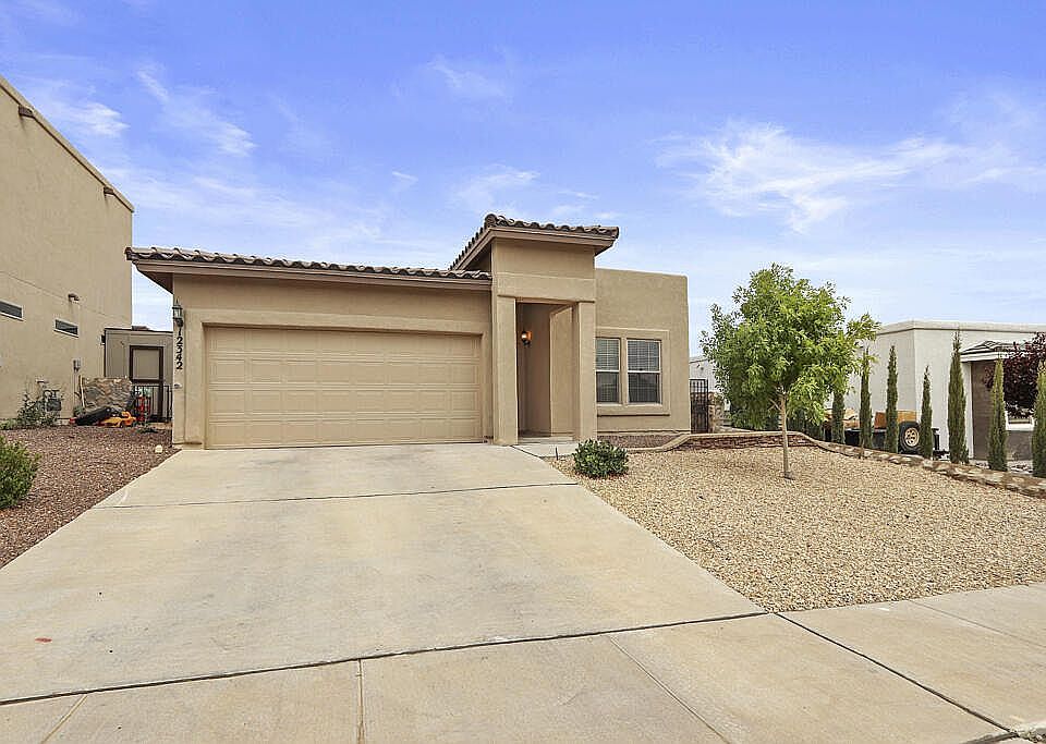 Front, 2 car garage, and two car drive way parking.