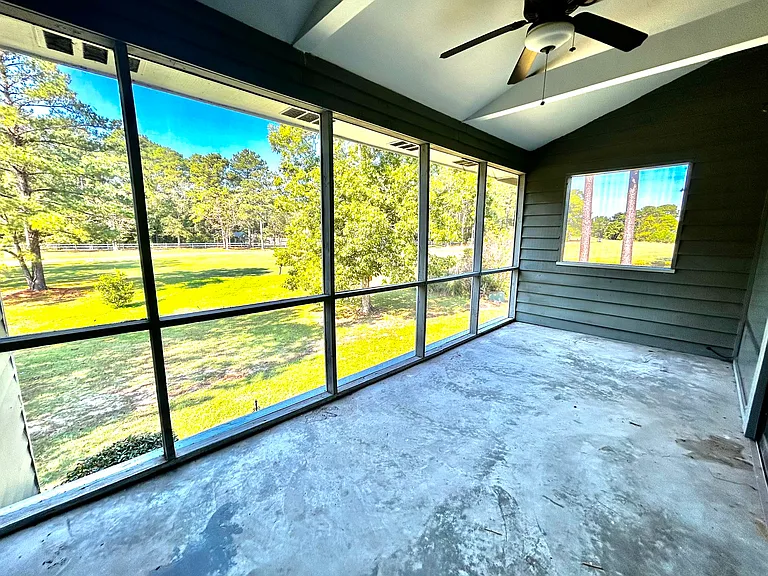 Enclosed Back Patio View with Ceiling Fan