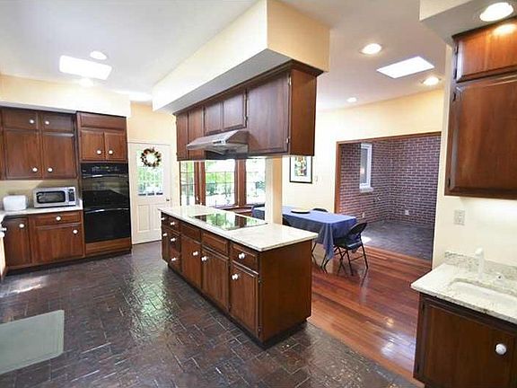 Kitchen. Granite counters, solid cherry cabinets and tile floors.