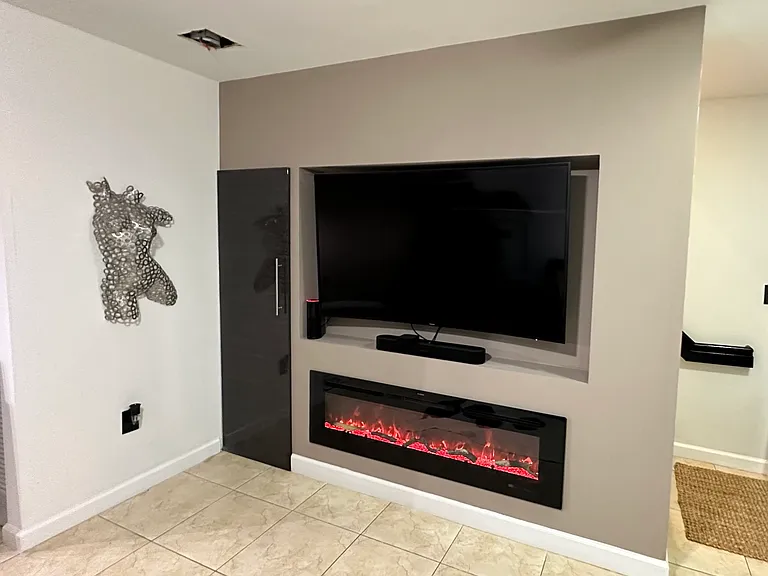 Custom Wall in Living Room area has space for a large TV and has a built-in Modern Fireplace
