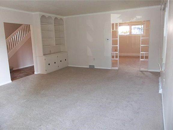 Custom-built shelves and cabinetry are added features of the living room.
