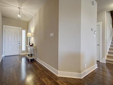 View of roomy foyer, perfect for greeting guests! Lush, warm, rich brown wood flooring and elegant c