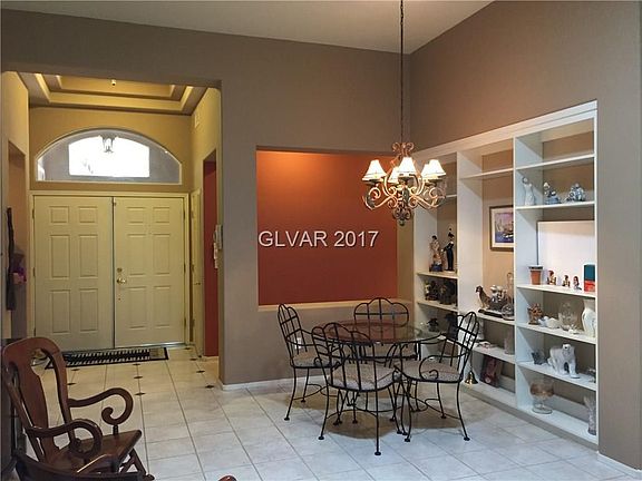 ENTRANCE FOYER LEADS TO FORMAL DINING AREA  WHICH FEATURES BUILT-IN SHELVES OFF LIVING ROOM. CERAMIC TILE @ LIVING & DINING ROOM.