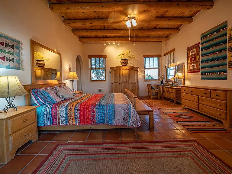 Master bedroom with 10 ft ceilings and Mexican tapestries