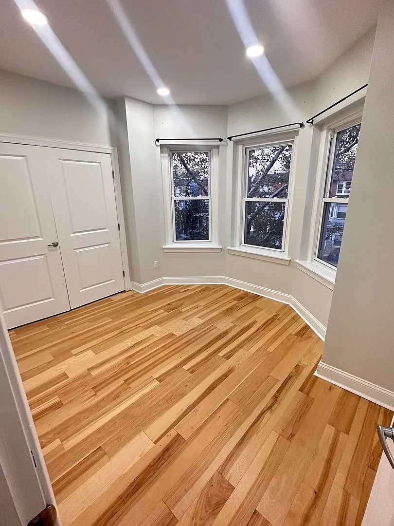 1-bedroom with a bay window and refinished hardwood — Photo 4