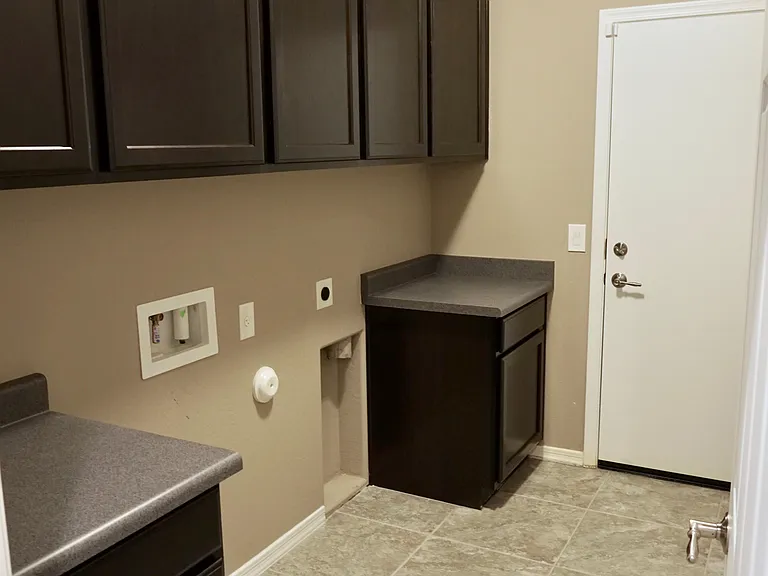 Utility room for washer/dryer with cabinets
