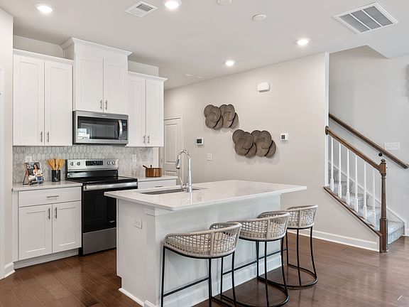 The well-appointed kitchen with a large island makes meal prep a breeze.