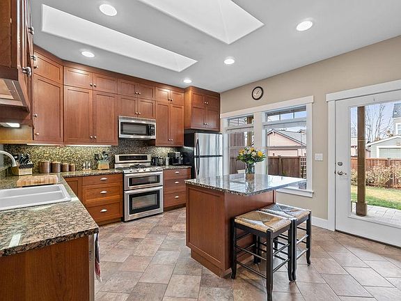 Large Kitchen leads to Back Porch and Yard