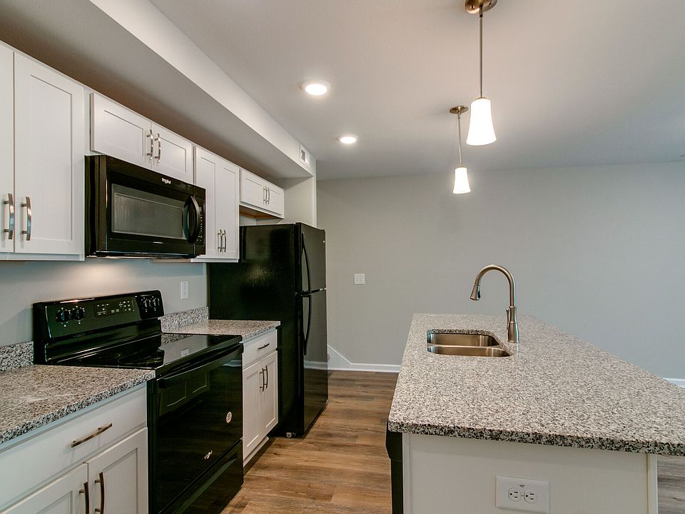 Kitchen with Large Granite top Island Dishwasher in island. Granite counter tops with overhang for additional seating at the island