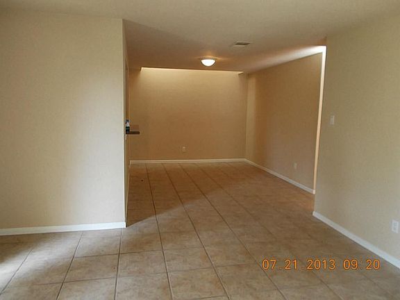 View from living area into dining area with new paint & ceramic tile floor.