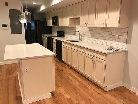 kitchen with island - garbage disposal, oven, microwave, refrigerator w/ ice maker, dishwasher