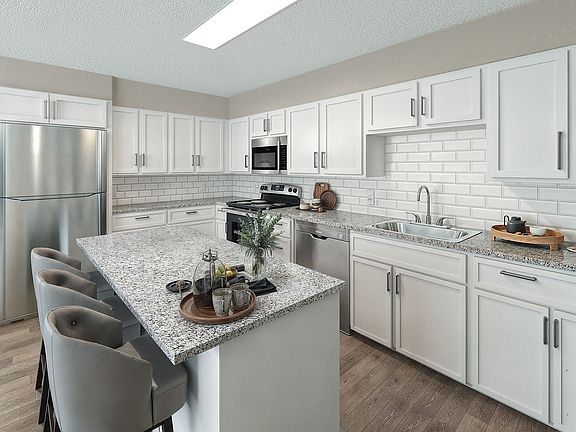Kitchen with stainless appliances, granite counters, and modern cabinetry
