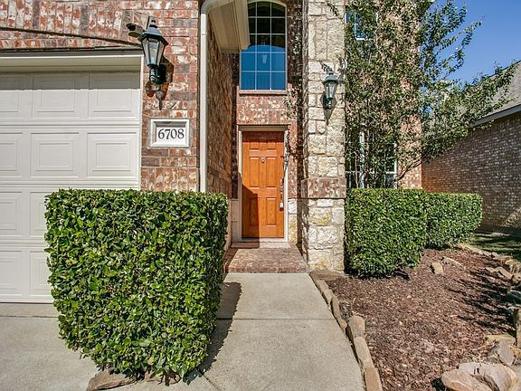 Nicely Landscaped entrance with a 2 car Front Garage.