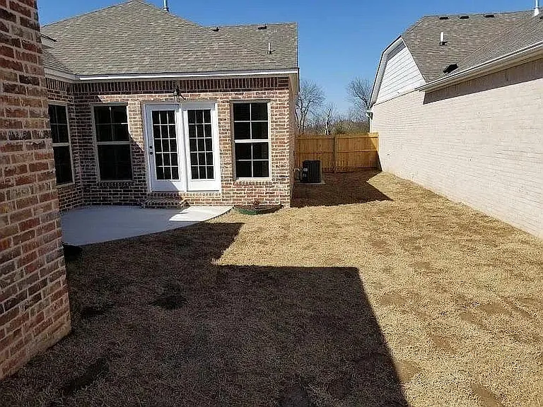 patio and fenced in yard area to the back and side of the house