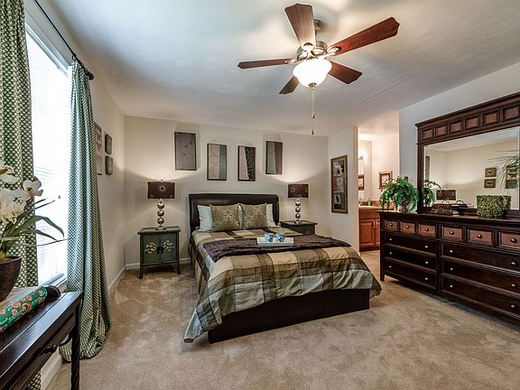 Bedroom with queen size bed, dresser and night stand.