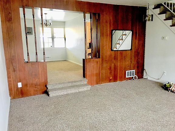 Living room area in front, then looking into the dining room, with the kitchen off the right side in the back.