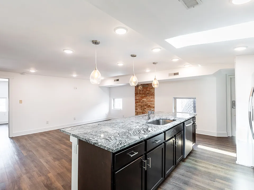Kitchen has beautiful granite counters, wood cabinetry, dishwasher, garbage disposal and stainless appliances.