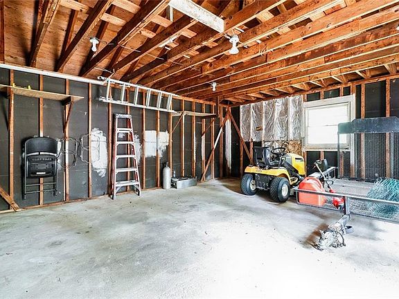 Oversized Detached Garage has room for vehicles but would be perfect for a workshop or for additional storage space.