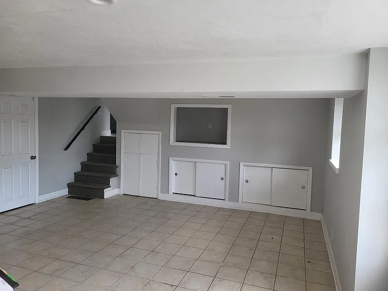 lower level living space access to upper level, utility room with laundry facilities, full bathroom and built in storage space