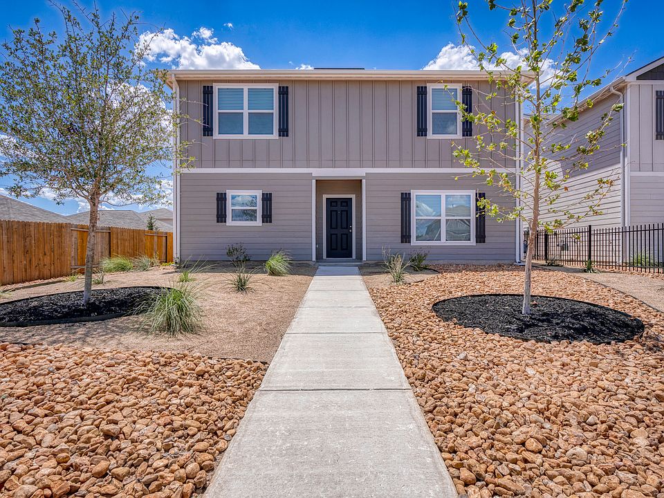 Exterior of the Young plan with professional front yard landscaping.