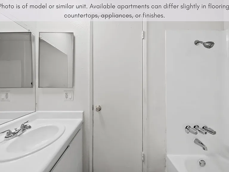 Clean and functional bathroom with a full tub/shower and generous vanity space.