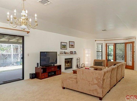 This large room is located right off of the kitchen, making it convenient to add a table for a formal dining area. In addition, there is plenty of space in the living room in front of the fireplace. French doors take you to the back patio, or a slider ta