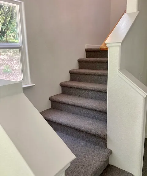 Stairs to bedrooms, study, and upstairs bathroom.