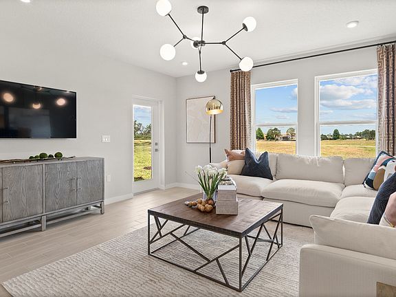 Jupiter Model open concept living room by DRB Homes at Grasslands West, a new construction home in L