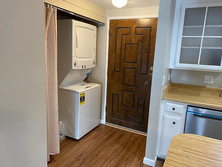 Front entry with excellent security screen door, and new stacking washer and dryer in laundry area_
