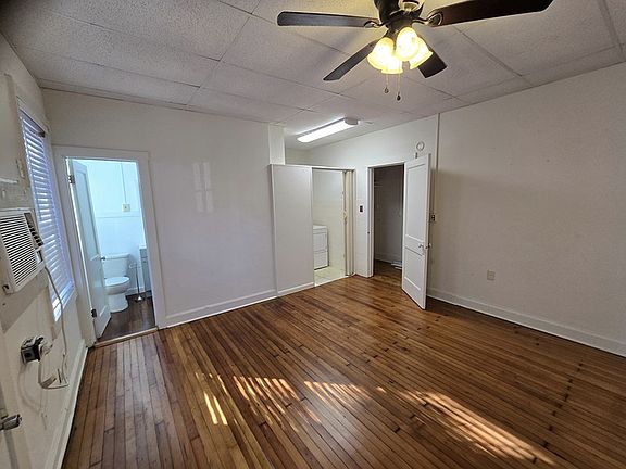 bedroom with bathroom to left and large storage to right