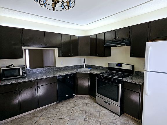 Server window opens to dining room/living area providing a seamless flow between the spaces