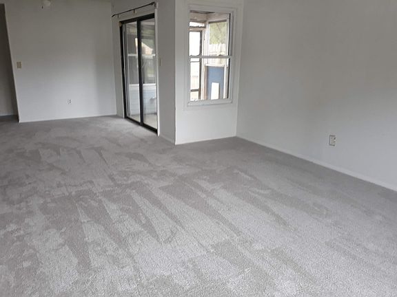 Living room and dining room with side porch access