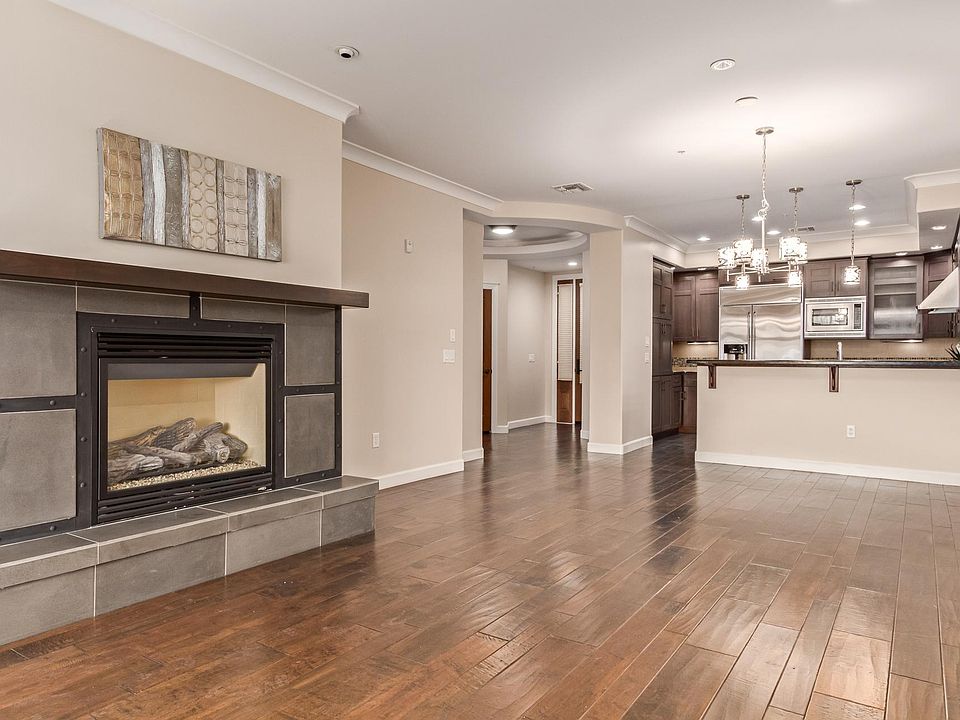 LARGE GREAT ROOM WITH FIRE PLACE, VAULTED CEILINGS, FANS, WOOD FLOORS, & MOUNTAIN VIEWS