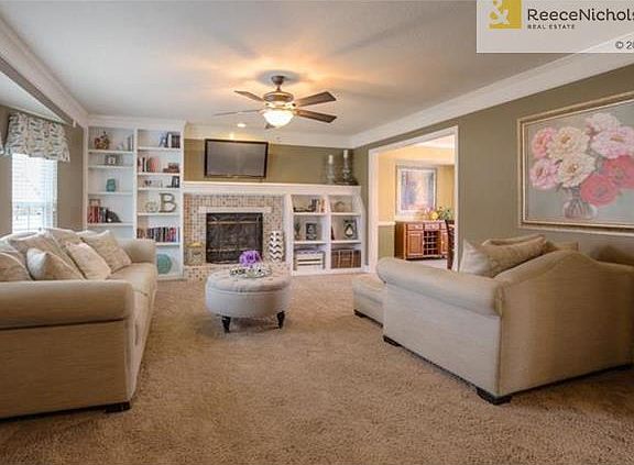 The Family Room offers a bay window (newer windows), beautiful fireplace, built-in bookshelves on each side of the fireplace, ceiling fan and newer carpet.