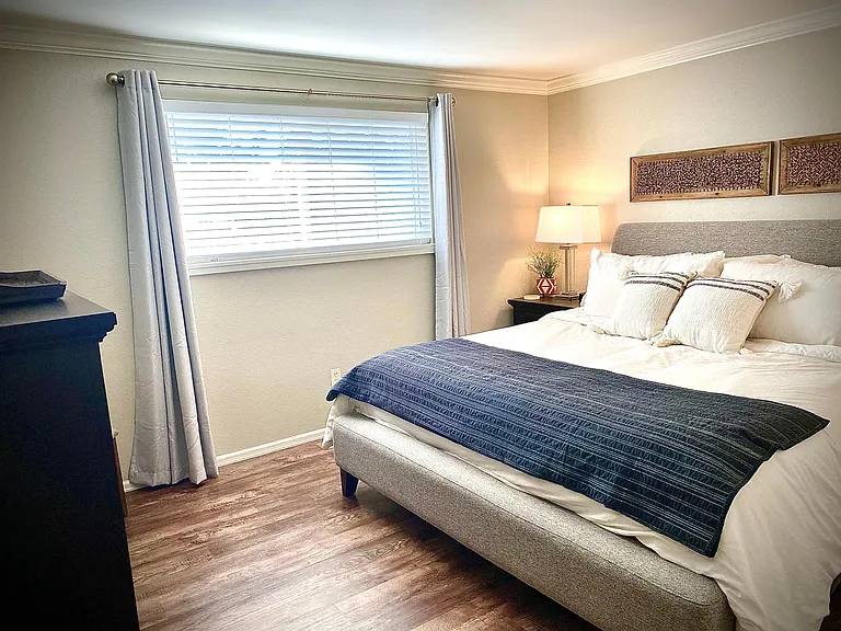 Primary bedroom is spacious - fits King bed, two bed tables and large dresser