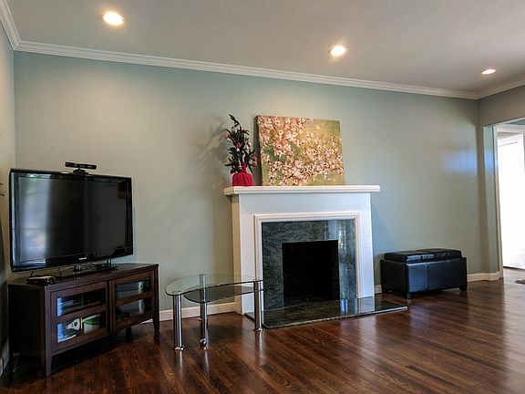 living room (furnished with TV stand, wide screen TV and cof