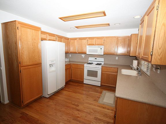 CLOSER LOOK FOR THE KITCHEN WITH CORIAN COUNTER TOPS, NEWER APPLIANCES.