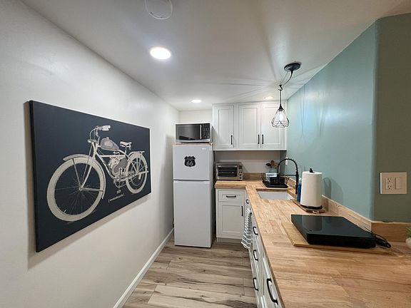 Kitchen with butcher block countertop.